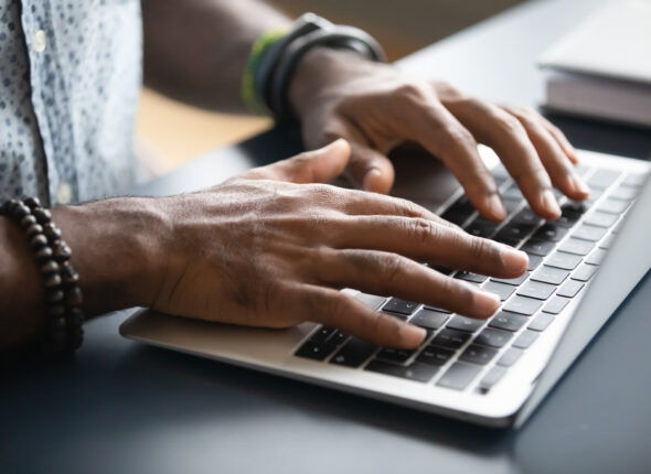 Close,Up,Image,African,Male,Hands,Typing,On,Laptop,Keyboard.