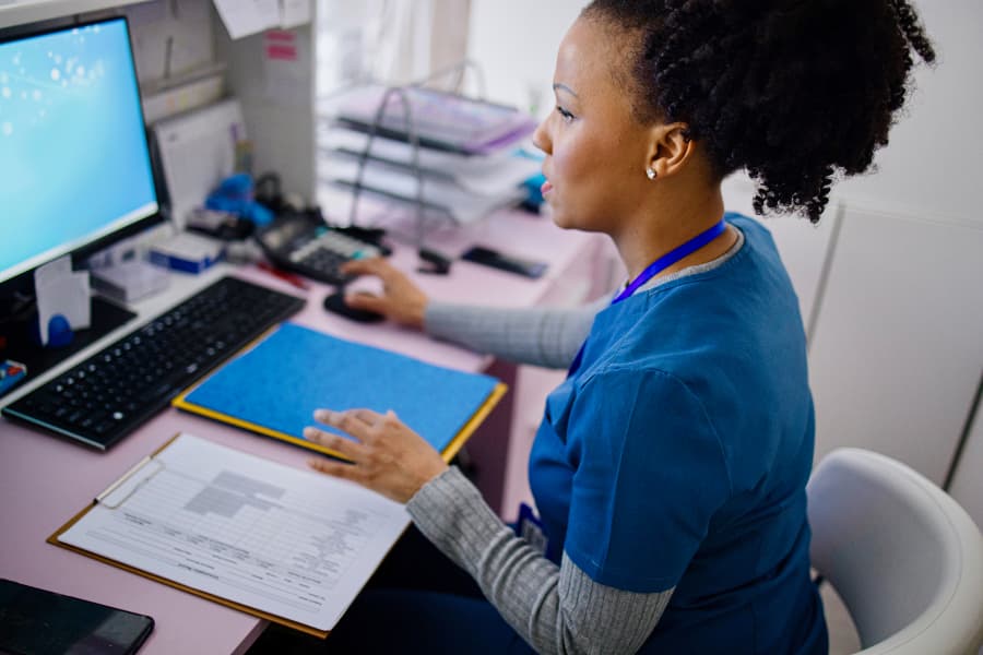 Medical office assistant working at computer